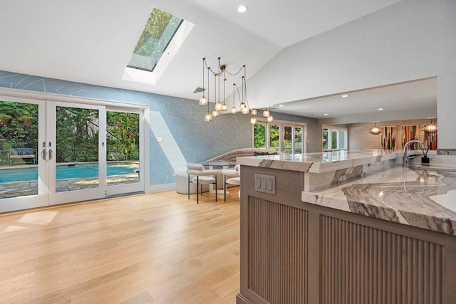 2 Field Ln, Roslyn Heights, NY 11577 - kitchen with vaulted ceiling, wallpapered walls, decorative light fixtures, light wood-type flooring, and healthy amount of natural light