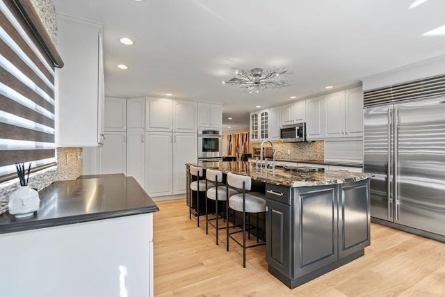 2 Field Ln, Roslyn Heights, NY 11577 - kitchen featuring appliances with stainless steel finishes, recessed lighting, white cabinets, light wood-style floors, and decorative backsplash