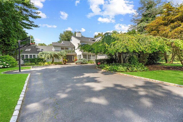 2 Field Ln, Roslyn Heights, NY 11577 - view of property hidden behind natural elements with a front yard and a chimney