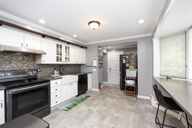 11 Myrtle Ln, Levittown, NY 11756 - kitchen with black appliances, under cabinet range hood, baseboards, decorative backsplash, and crown molding