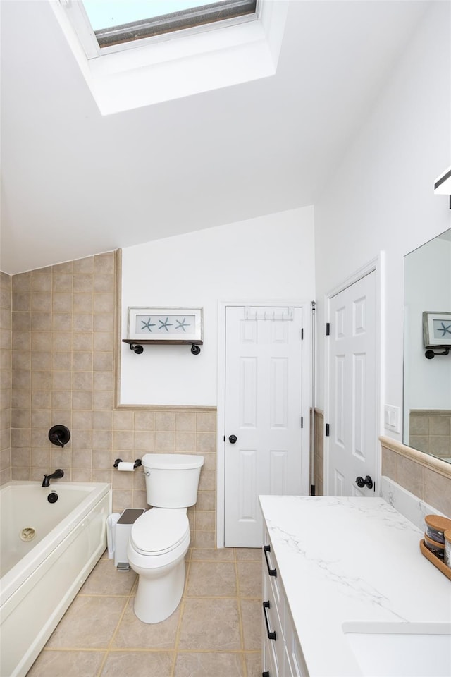 11 Myrtle Ln, Levittown, NY 11756 - bathroom featuring tile walls, vanity, toilet, tile patterned floors, and a skylight