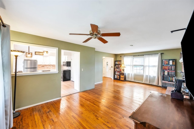 301 Maple Ave, Patchogue, NY 11772 - living area featuring a ceiling fan, baseboards, and light wood-style floors