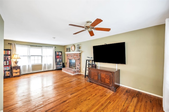 301 Maple Ave, Patchogue, NY 11772 - living area with ceiling fan, wood finished floors, baseboards, and a fireplace