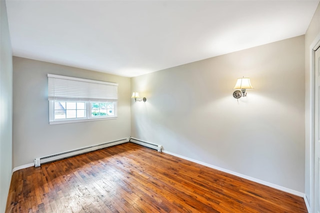 301 Maple Ave, Patchogue, NY 11772 - unfurnished room featuring wood-type flooring, baseboards, a baseboard radiator, and baseboard heating