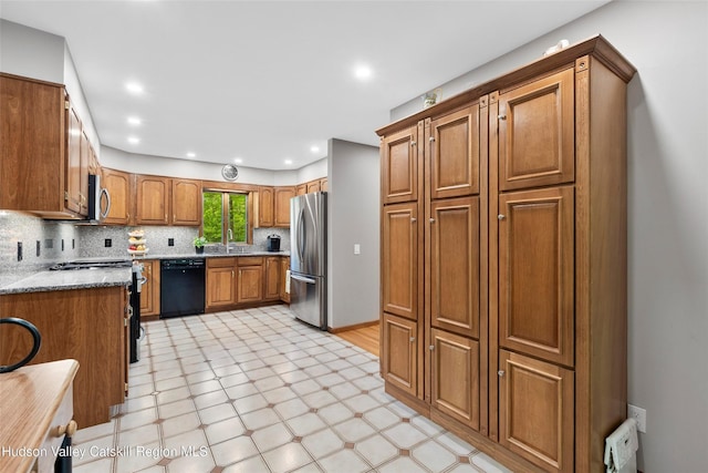 48 Deer Park Rd, Cairo, NY 12473 - kitchen with stainless steel appliances, a sink, brown cabinets, light floors, and tasteful backsplash