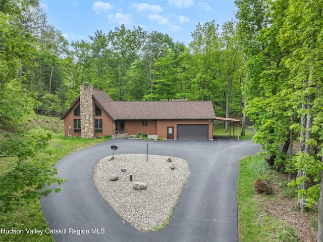 48 Deer Park Rd, Cairo, NY 12473 - view of front of home with a chimney, driveway, a garage, a forest view, and a shingled roof