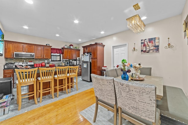 3632 Willett Ave, Bronx, NY 10467 - dining room featuring light wood finished floors, a chandelier, and recessed lighting