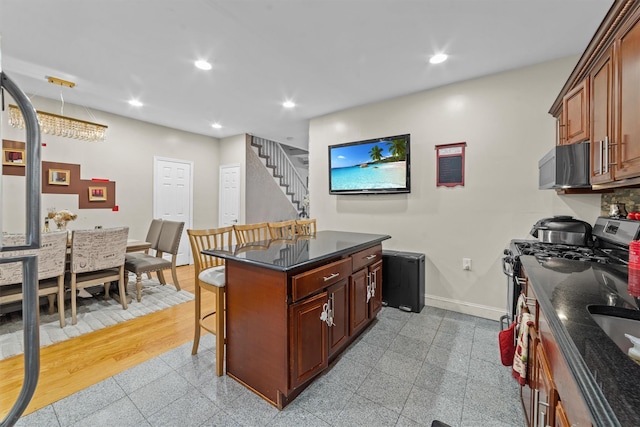 3632 Willett Ave, Bronx, NY 10467 - kitchen featuring stainless steel microwave, a breakfast bar, recessed lighting, baseboards, and granite floors