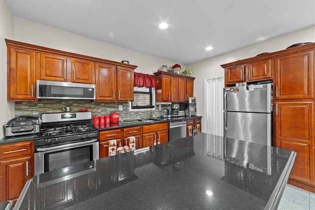 3632 Willett Ave, Bronx, NY 10467 - kitchen with appliances with stainless steel finishes, decorative backsplash, recessed lighting, dark stone counters, and a sink