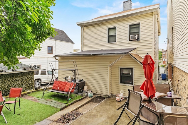 3632 Willett Ave, Bronx, NY 10467 - rear view of property featuring a chimney, a patio area, and a yard