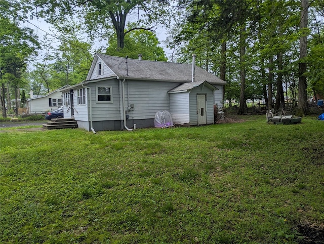 25 Birch St, Pine Bush, NY 12721 - back of property featuring a lawn and roof with shingles