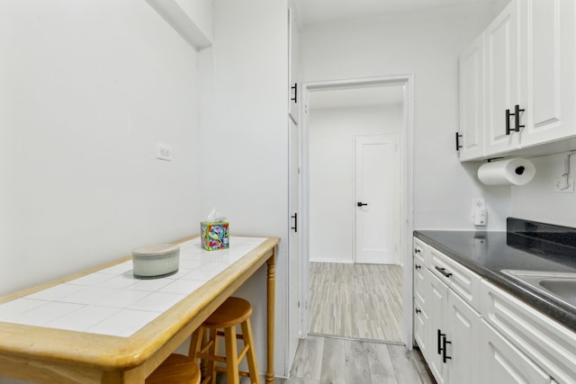 88-09 35th Ave Unit 5K, Jackson Heights, NY 11372 - kitchen featuring white cabinetry and light wood-style floors