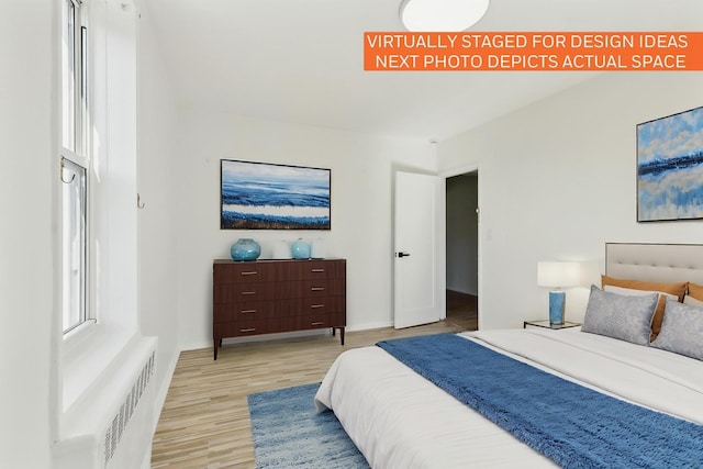 88-09 35th Ave Unit 5K, Jackson Heights, NY 11372 - bedroom with light wood-type flooring, radiator heating unit, and baseboards