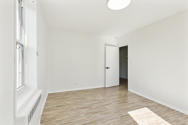 88-09 35th Ave Unit 5K, Jackson Heights, NY 11372 - empty room with light wood-style floors, baseboards, and radiator