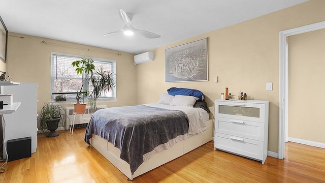 3217 Tenbroeck Ave, Bronx, NY 10469 - bedroom with light wood-style flooring, a wall mounted air conditioner, and ceiling fan