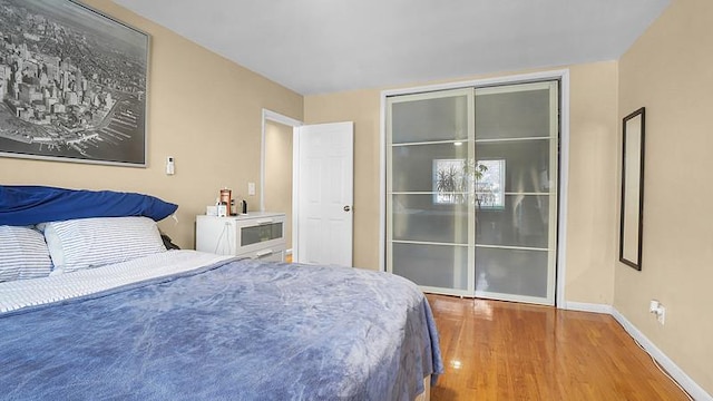 3217 Tenbroeck Ave, Bronx, NY 10469 - bedroom with wood finished floors, a closet, and baseboards