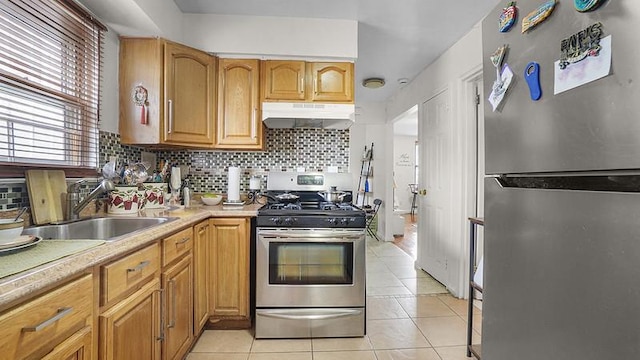 3217 Tenbroeck Ave, Bronx, NY 10469 - kitchen with stainless steel appliances, under cabinet range hood, decorative backsplash, and light tile patterned floors