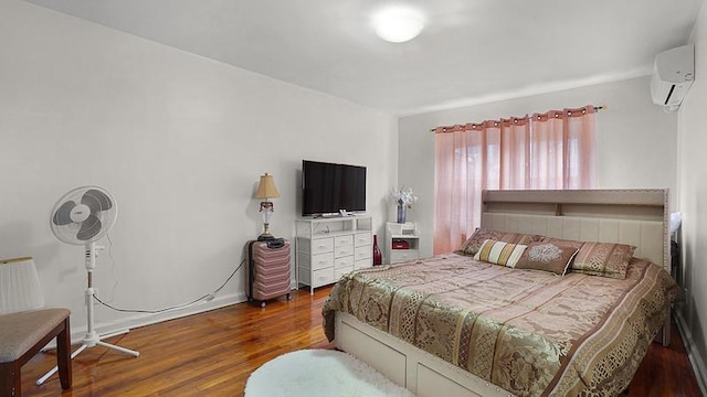 3217 Tenbroeck Ave, Bronx, NY 10469 - bedroom with a wall mounted AC, wood finished floors, and baseboards