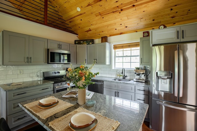 235 Terwilliger Rd, Livingston Manor, NY 12758 - kitchen featuring appliances with stainless steel finishes, a sink, vaulted ceiling, light stone countertops, and tasteful backsplash