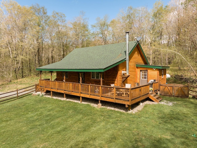 235 Terwilliger Rd, Livingston Manor, NY 12758 - rear view of house featuring a shingled roof, faux log siding, a wooden deck, and a gate