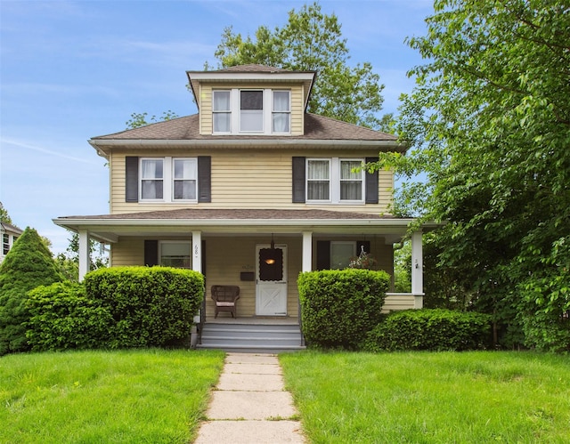 68 Boltis St, Mount Kisco, NY 10549 - american foursquare style home featuring a porch, a front lawn, and a shingled roof