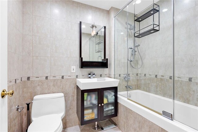 728 Ocean View Ave Unit A2, Brooklyn, NY 11235 - bathroom featuring tile walls, tiled shower / bath, toilet, and vanity