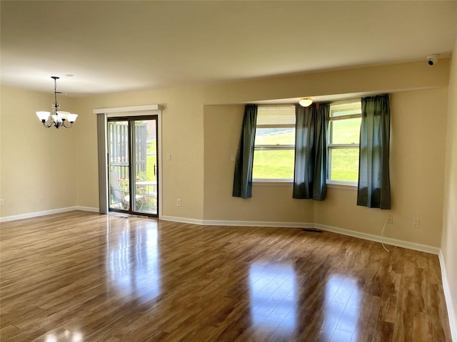 6DEVONCOURT Devon Unit B, Yorktown Heights, NY 10598 - spare room featuring healthy amount of natural light, a chandelier, wood finished floors, and baseboards