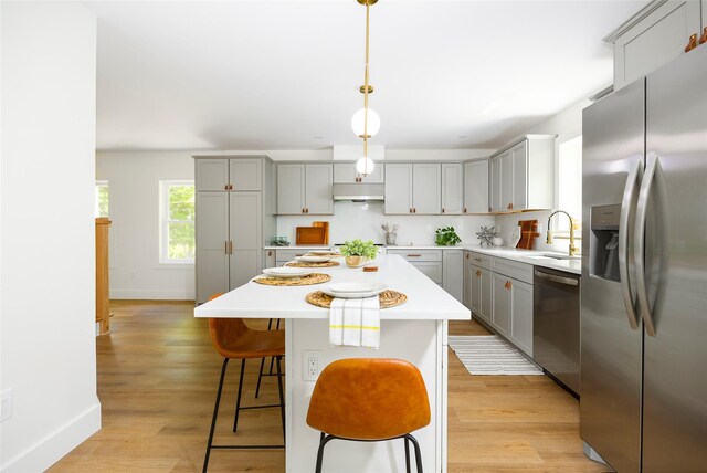 300 Seminary Hill Rd, Carmel, NY 10512 - kitchen with appliances with stainless steel finishes, gray cabinets, under cabinet range hood, a sink, and baseboards