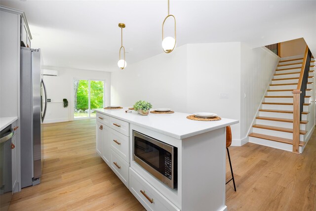300 Seminary Hill Rd, Carmel, NY 10512 - kitchen featuring appliances with stainless steel finishes, light wood-style floors, a kitchen bar, and light countertops