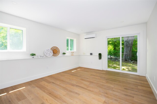 300 Seminary Hill Rd, Carmel, NY 10512 - empty room featuring a wall mounted air conditioner, light wood-style flooring, and baseboards