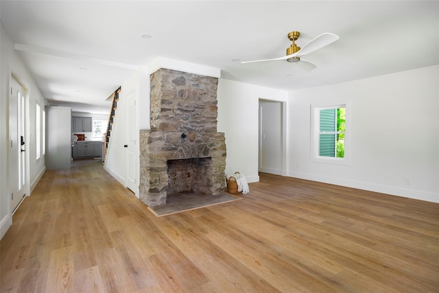 300 Seminary Hill Rd, Carmel, NY 10512 - unfurnished living room with light wood-style floors, a ceiling fan, baseboards, and a fireplace