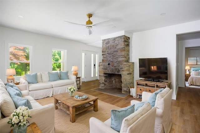 300 Seminary Hill Rd, Carmel, NY 10512 - living room featuring wood finished floors, a ceiling fan, and a stone fireplace