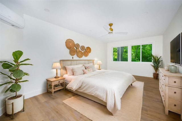 300 Seminary Hill Rd, Carmel, NY 10512 - bedroom featuring a wall mounted air conditioner, baseboards, and light wood-type flooring
