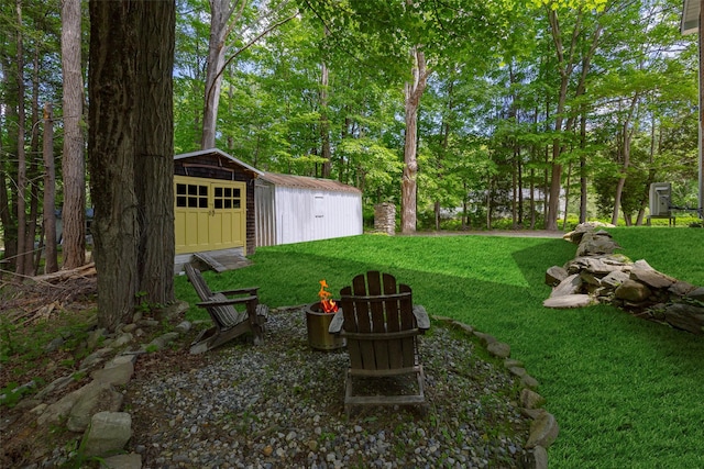300 Seminary Hill Rd, Carmel, NY 10512 - view of grassy yard featuring a detached garage and an outdoor fire pit