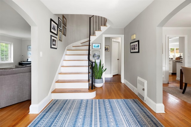 21 Deepdale Dr, Manhasset, NY 11030 - stairs with wood finished floors, arched walkways, and baseboards