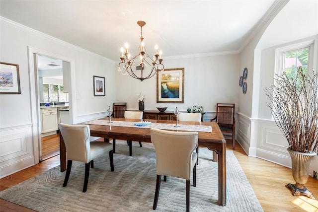 21 Deepdale Dr, Manhasset, NY 11030 - dining space featuring healthy amount of natural light, a chandelier, light wood-style floors, crown molding, and a decorative wall