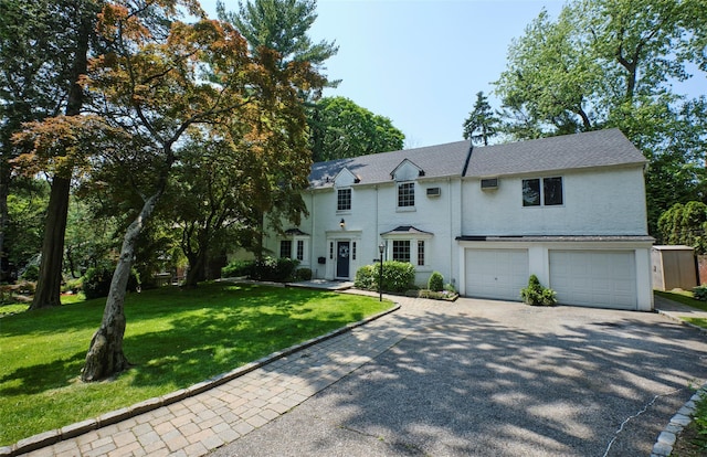 21 Deepdale Dr, Manhasset, NY 11030 - view of front of house featuring driveway, a garage, and a front yard