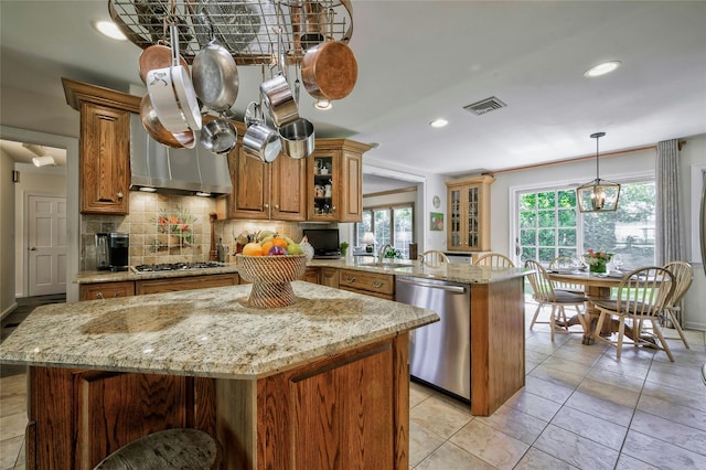28 Valley Rd, Manhasset, NY 11030 - kitchen featuring stainless steel appliances, brown cabinets, tasteful backsplash, a sink, and recessed lighting