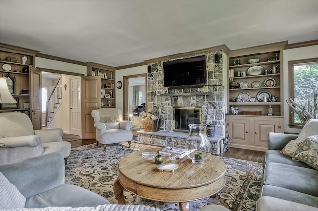 28 Valley Rd, Manhasset, NY 11030 - living room featuring crown molding, a stone fireplace, wood finished floors, and stairs