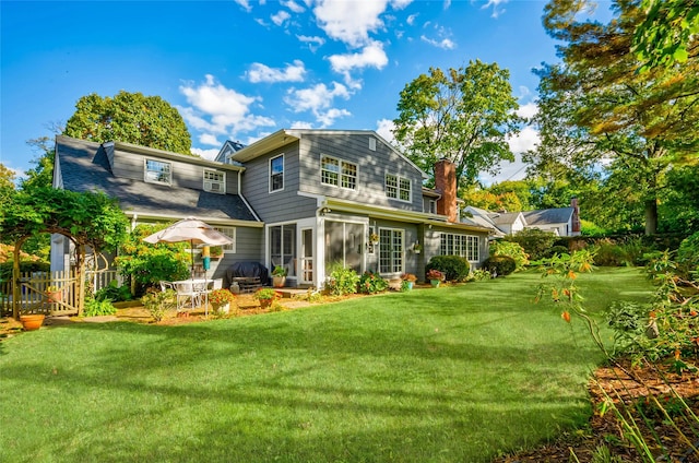 28 Valley Rd, Manhasset, NY 11030 - rear view of property featuring a sunroom, a chimney, and a patio area