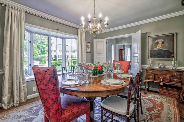 28 Valley Rd, Manhasset, NY 11030 - dining room featuring a chandelier, crown molding, healthy amount of natural light, and wood finished floors