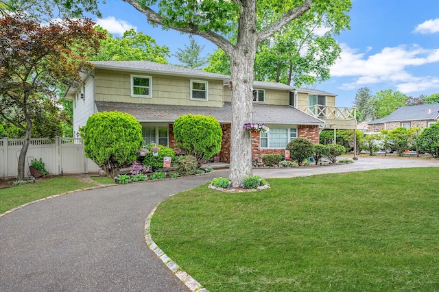 40 Monroe Ave, Brentwood, NY 11717 - view of front of home with roof with shingles, driveway, and brick siding