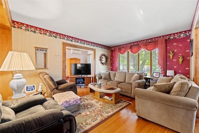 45-31 169th St, Flushing, NY 11358 - living room with a wall mounted AC, wallpapered walls, and wood-type flooring