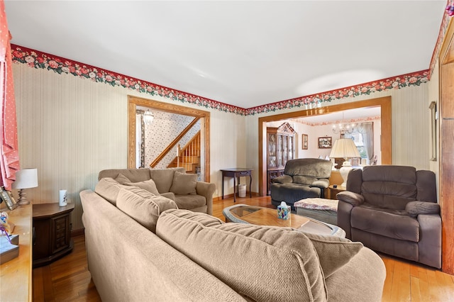 45-31 169th St, Flushing, NY 11358 - living room with wallpapered walls, hardwood / wood-style flooring, and stairs