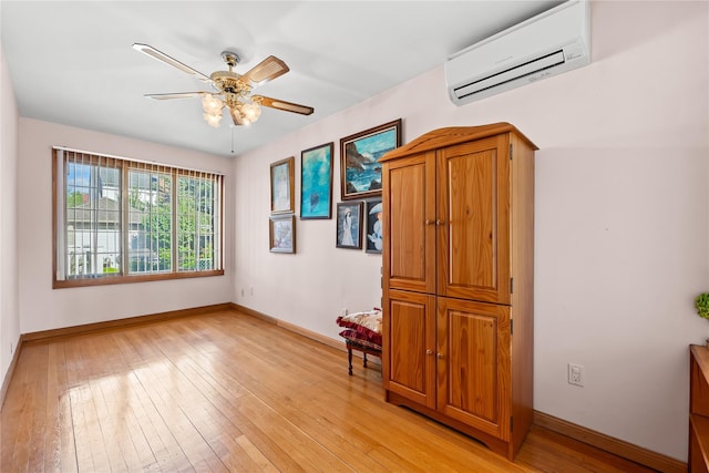 45-31 169th St, Flushing, NY 11358 - empty room with a wall mounted AC, light wood-style flooring, baseboards, and ceiling fan