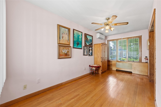 45-31 169th St, Flushing, NY 11358 - spare room featuring radiator, an AC wall unit, light wood finished floors, and a ceiling fan