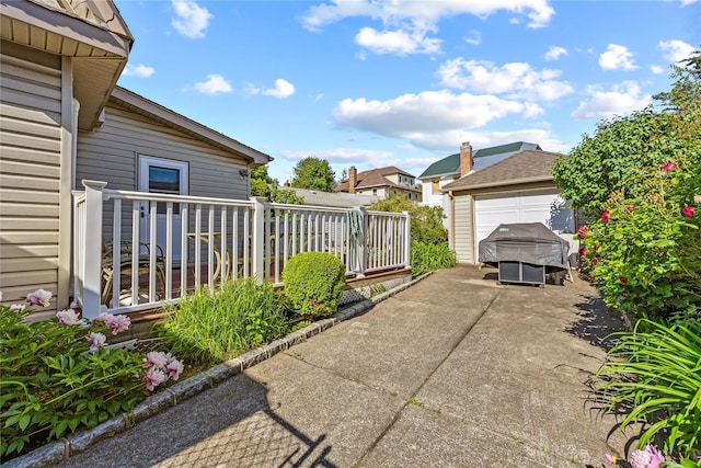 45-31 169th St, Flushing, NY 11358 - view of patio with a garage and driveway
