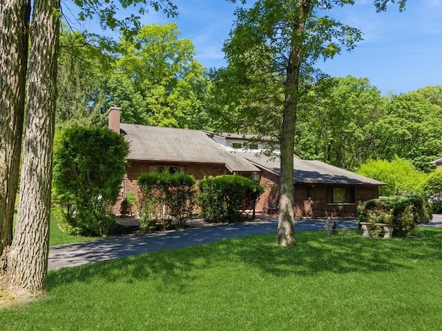 3 Brookland Farms Rd, Poughkeepsie, NY 12601 - view of front facade featuring a front lawn, brick siding, a chimney, and asphalt driveway