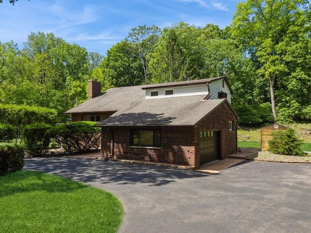 3 Brookland Farms Rd, Poughkeepsie, NY 12601 - view of front of property with driveway, an attached garage, a chimney, a shingled roof, and brick siding