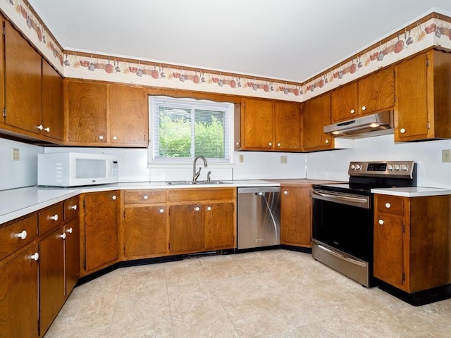 3 Brookland Farms Rd, Poughkeepsie, NY 12601 - kitchen featuring appliances with stainless steel finishes, a sink, under cabinet range hood, and brown cabinets